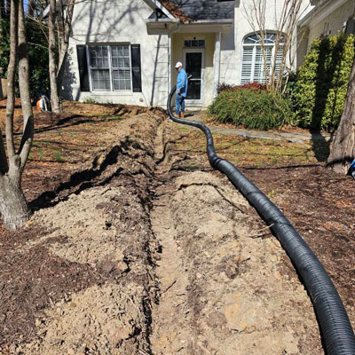 excavate and install drainage near building